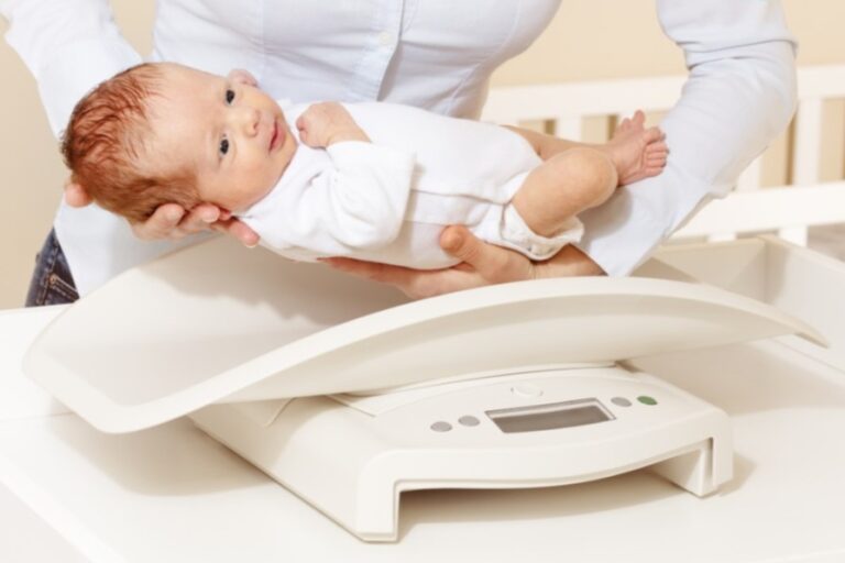 Baby being placed on a scale
