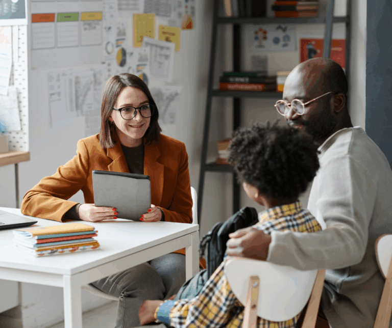 Father and child meet with teacher for an IEP meeting