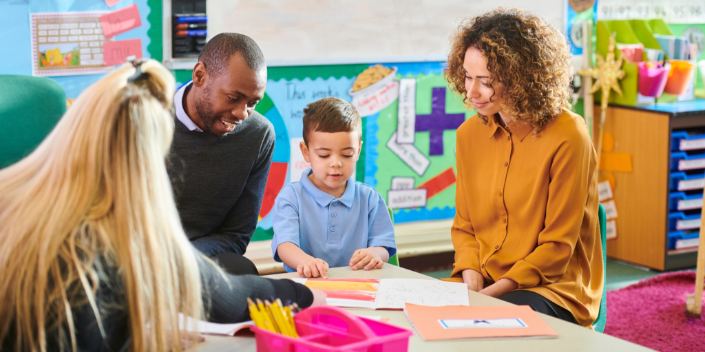 Parents and young child sitting together with a therapist in a bright, welcoming pediatric therapy office
